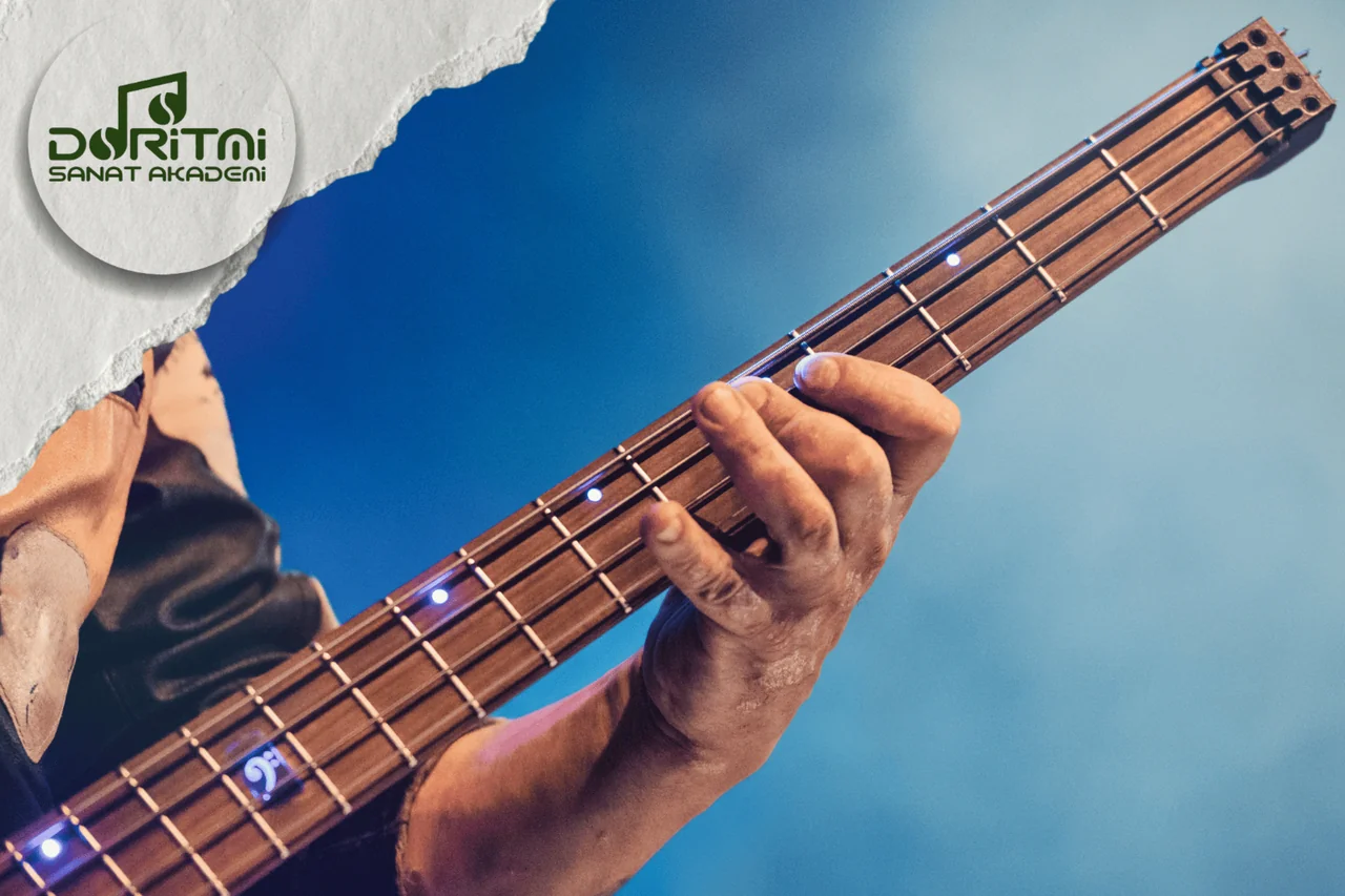 Mavi ışık altında bas gitar sapında hareket eden el.